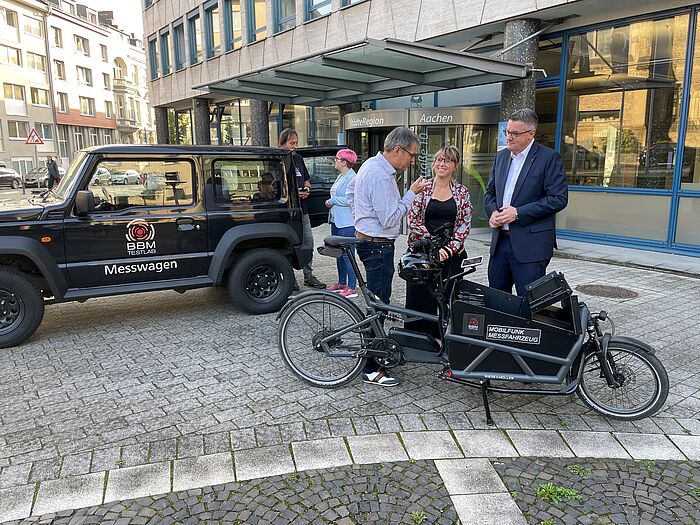 StädteRegionsrat Dr. Tim Grüttemeier und weitere Mitglieder der Verwaltung lassen sich die Messfahrzeuge genau erklären.